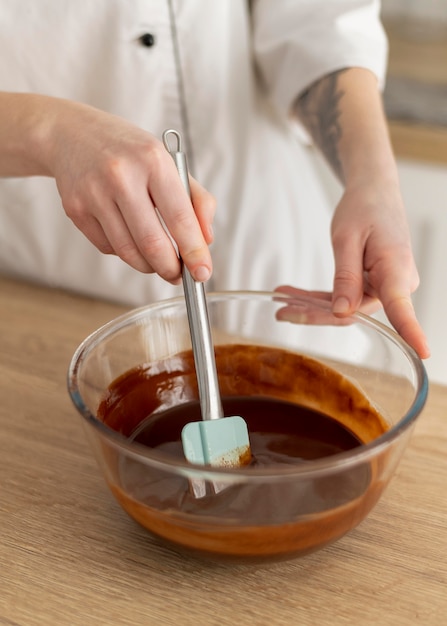 Free photo close up hand mixing chocolate