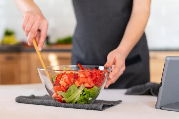 Free photo close up hand mixing salad