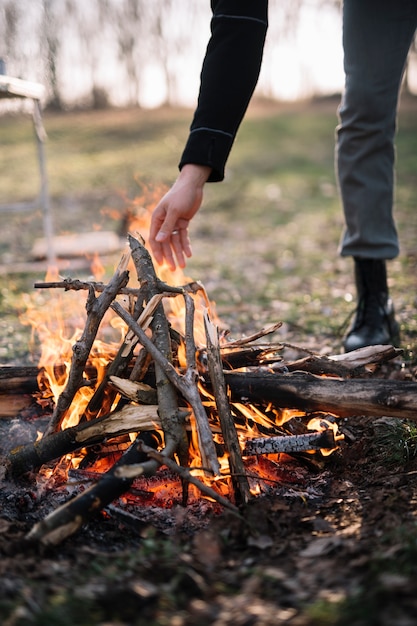 Close-up hand near campfire