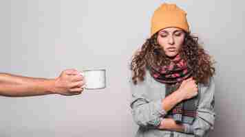 Free photo close-up of hand offering coffee to sick woman having cold and flu