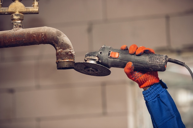 Close up of hand of repairman, professional builder working indoors, repairing