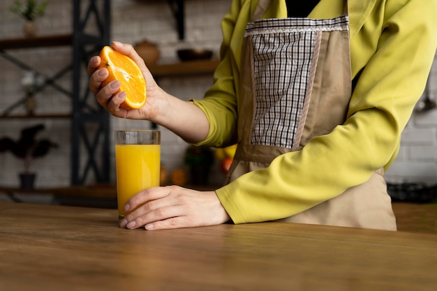 Free photo close up hand squeezing orange