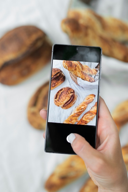 Free photo close up hand taking bread photos