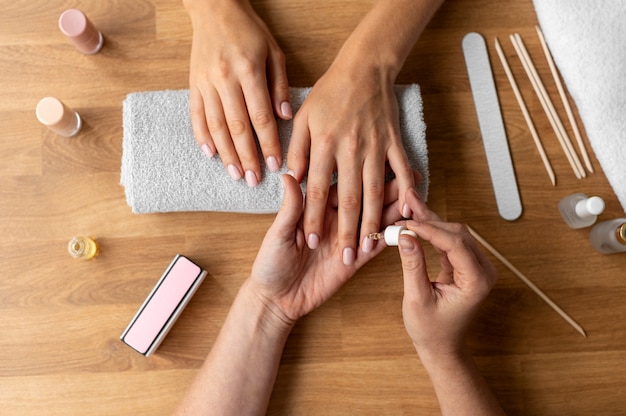 Free photo close up hand using cuticle oil