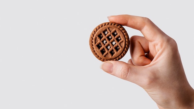 close up hand with chocolate biscuit