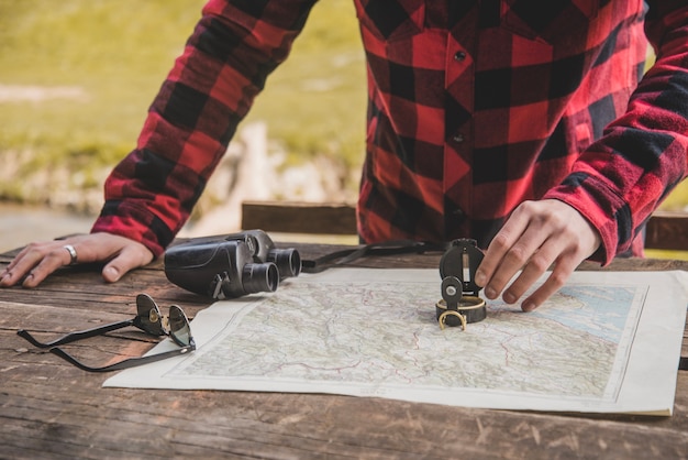 Free photo close-up of hand with compass on a map