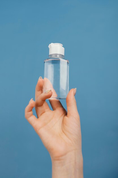 Close up hand with hand sanitizer bottle