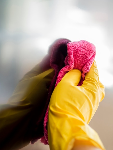 Free Photo close-up hand with rubber glove disinfecting