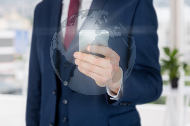 Close-up of hand with smartphone and world map