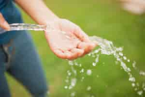 Free photo close-up of hand with a stream of water