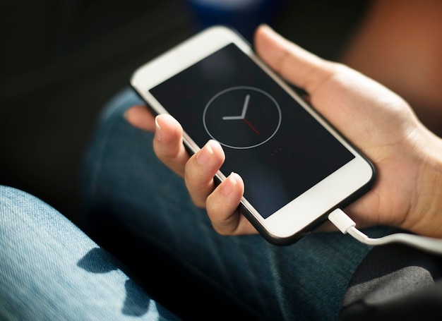 Close up of hands charging mobile phone