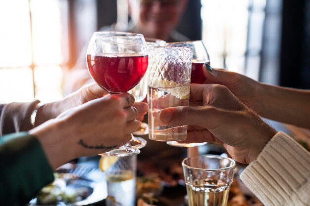 Close up on hands cheering drinks