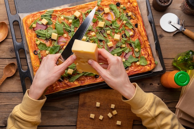 Close up hands cutting cheese