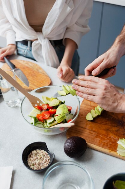 Close up hands cutting vegetables