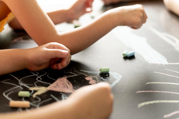 Free Photo close up hands drawing with chalk