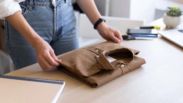 Close up hands folding shirt