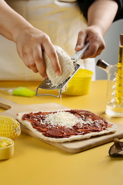 Free photo close up hands grating cheese