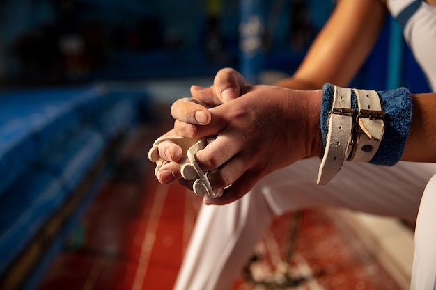 Free Photo close up of hands of gymnast training in gym, flexible and active.