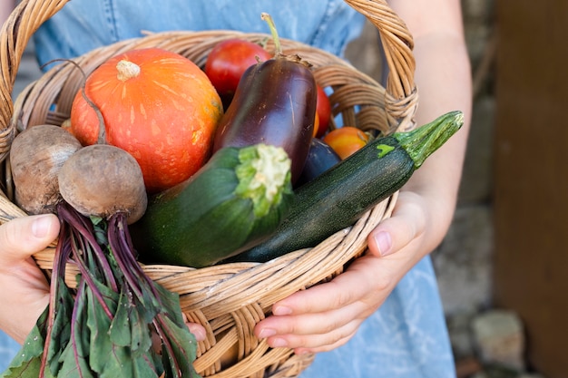 Free photo close-up hands holding basket with vegetables