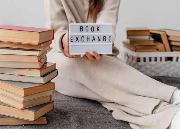 Free photo close up hands holding book exchange sign