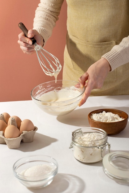 Free Photo close up hands holding bowl and whisk