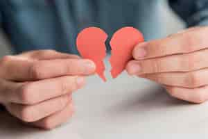 Free photo close-up hands holding broken heart