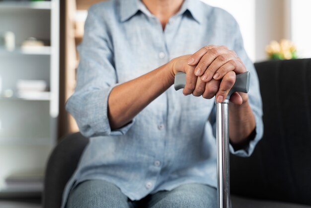 Close up hands holding cane