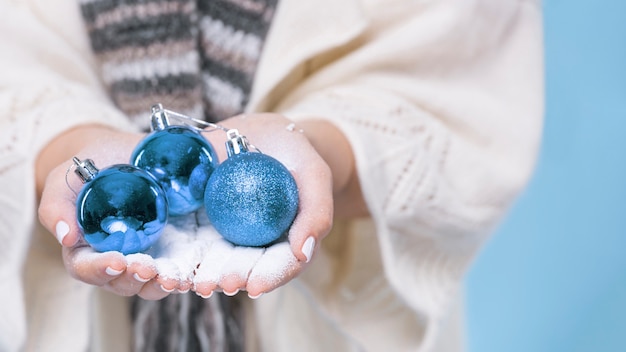 Close-up hands holding christmas balls