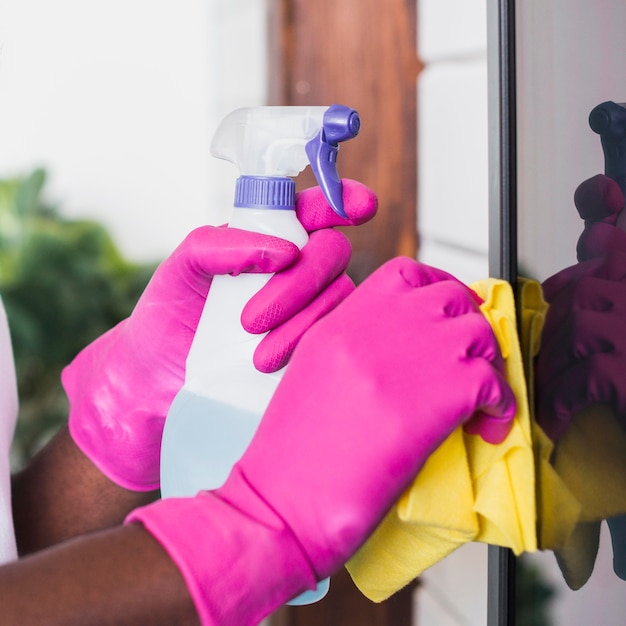 Close-up hands holding cleaning supplies