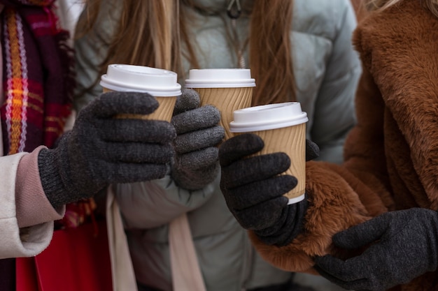 Free Photo close-up hands holding coffee cups