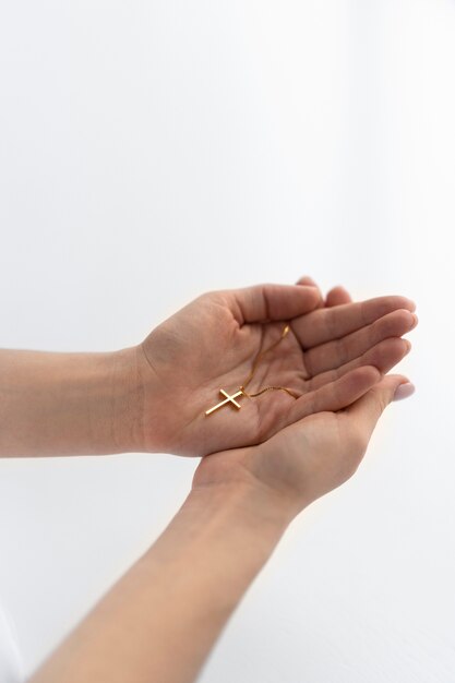 Close up hands holding crucifix