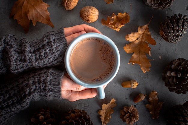 Free photo close up hands holding cup of hoc chocolate