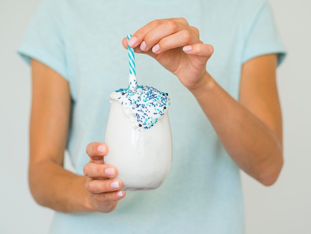 Free Photo close-up hands holding delicious shake