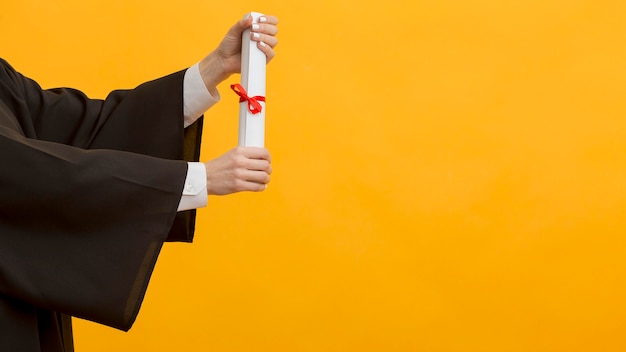 Close up hands holding diploma