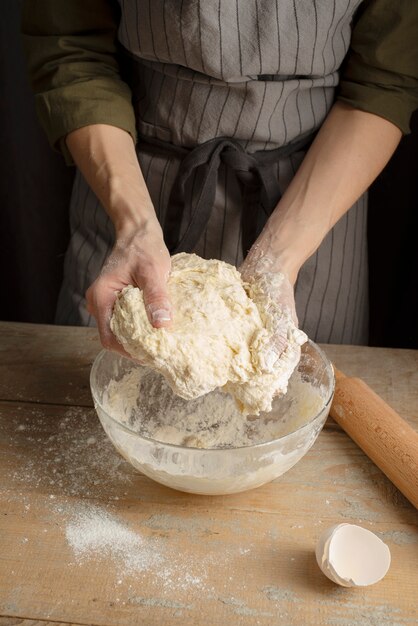 Close up hands holding dough