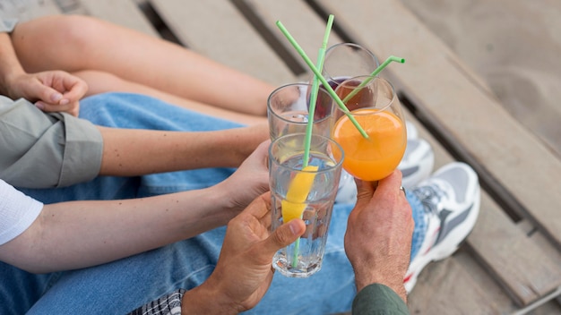 Free photo close-up hands holding drinks