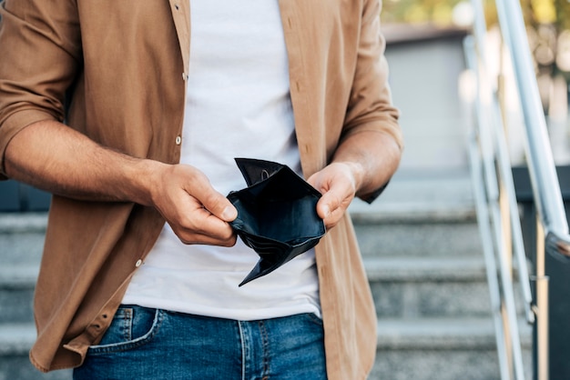 Free photo close-up hands holding empty wallet