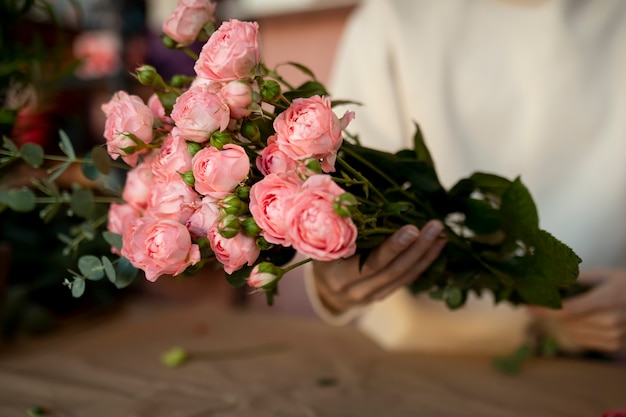 Close up hands holding flowers bouquet