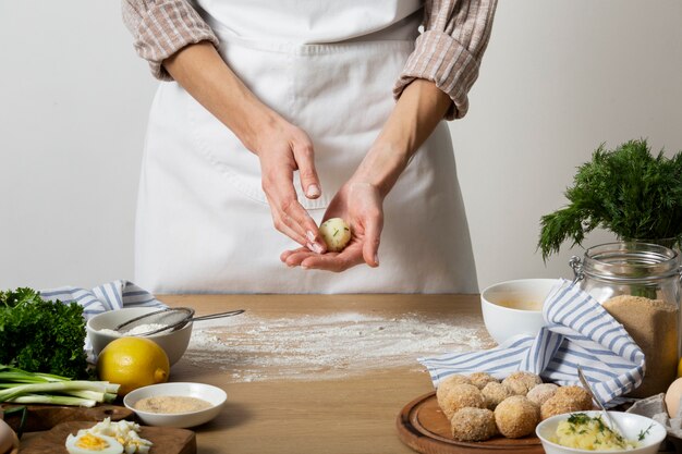 Close up hands holding food croquette