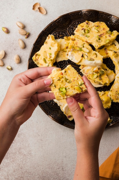 Close-up hands holding food piece