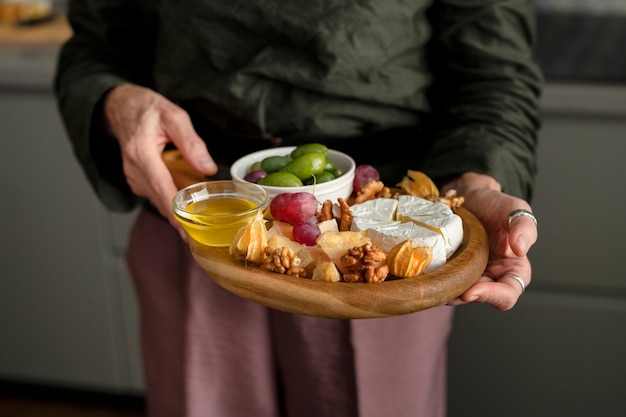 Free photo close up hands holding food plate