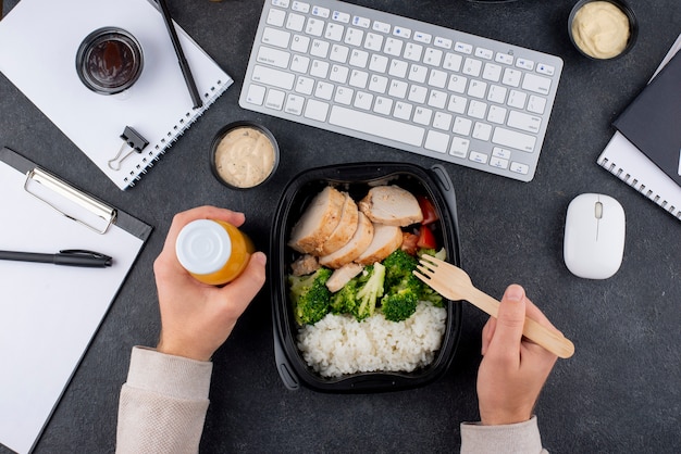 Close up hands holding fork and bottle