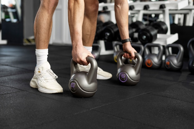 Free photo close up hands holding kettlebells