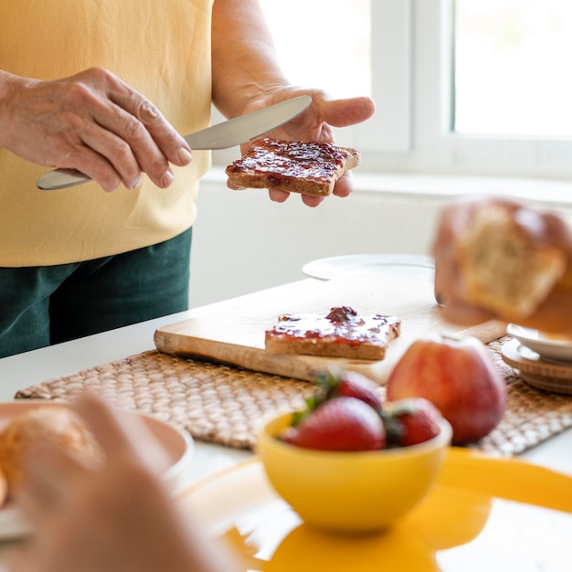 Close up hands holding knife and bread