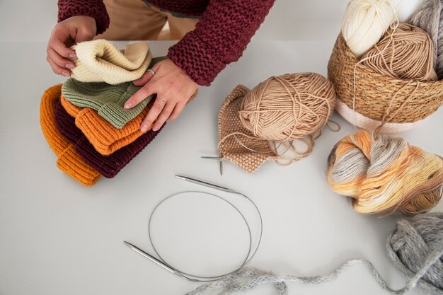 Close up hands holding knitted hats