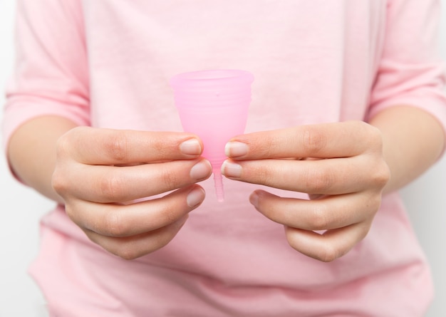 Close up hands holding menstrual cup