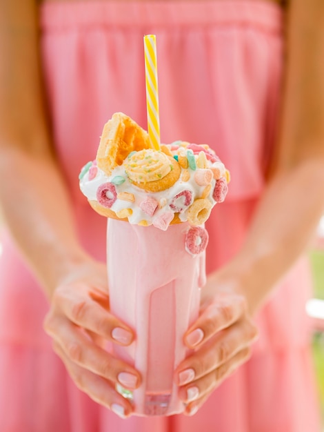 Free photo close-up hands holding milkshake