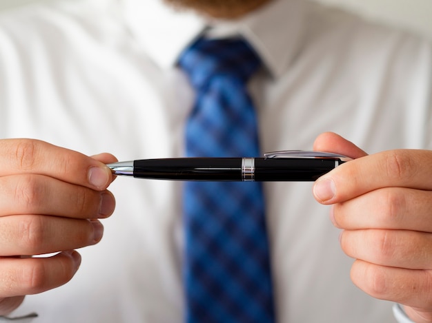 Free photo close-up hands holding pen mock-up