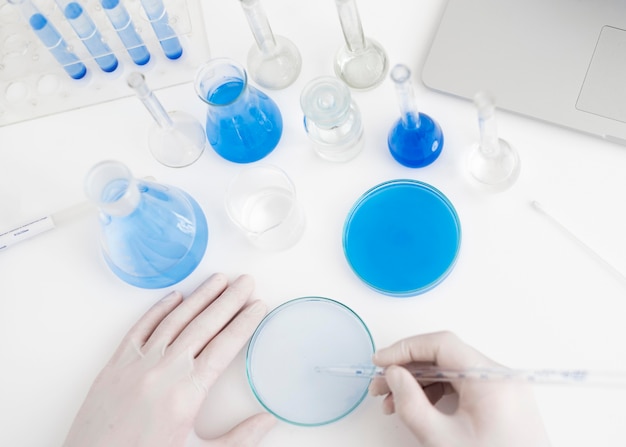 Close-up hands holding pipette