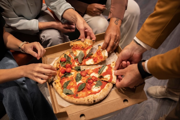 Close up hands holding pizza slices